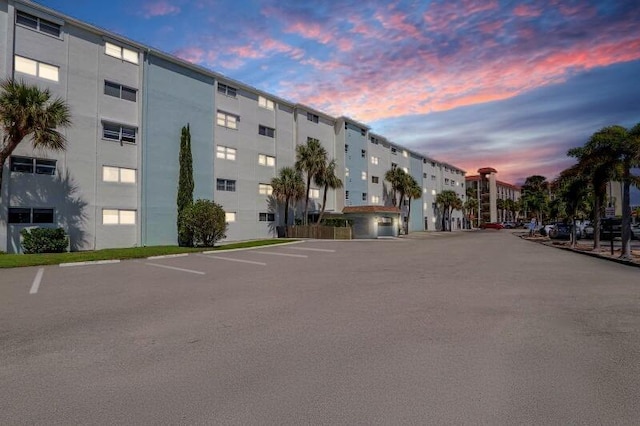 property at dusk with uncovered parking