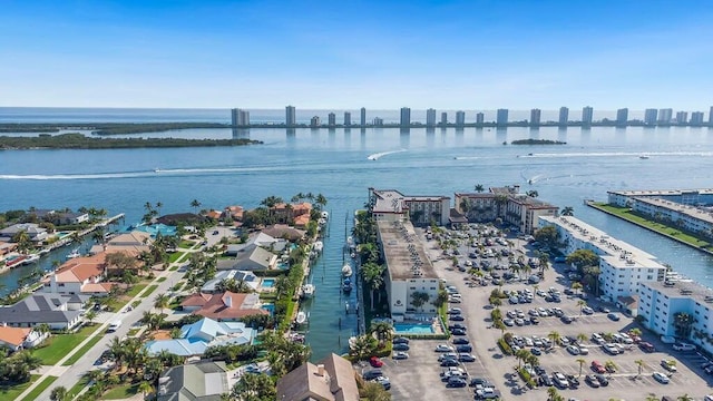 birds eye view of property with a water view and a city view