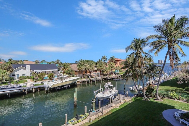 view of dock featuring a lawn, a water view, and boat lift