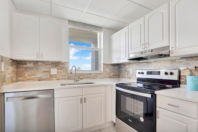 kitchen with appliances with stainless steel finishes, a sink, white cabinets, and under cabinet range hood