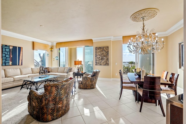 living room featuring a chandelier, ornamental molding, healthy amount of natural light, light tile patterned floors, and baseboards