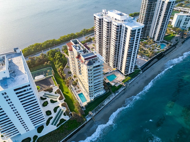 bird's eye view of waterfront with a beach and a pool