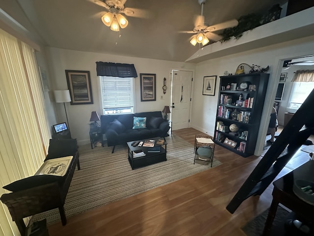 living room with wood-type flooring, lofted ceiling, and ceiling fan