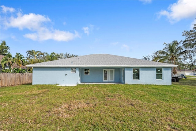 rear view of property with a lawn