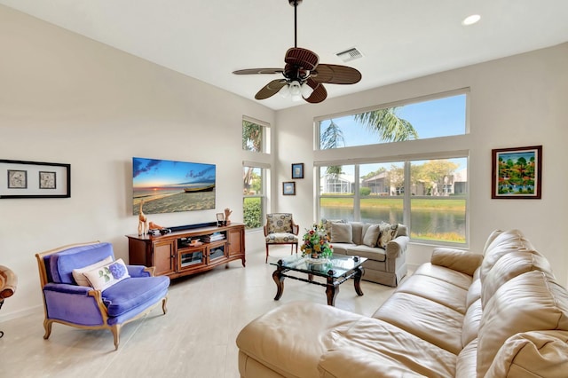 living room featuring visible vents, baseboards, a towering ceiling, ceiling fan, and recessed lighting