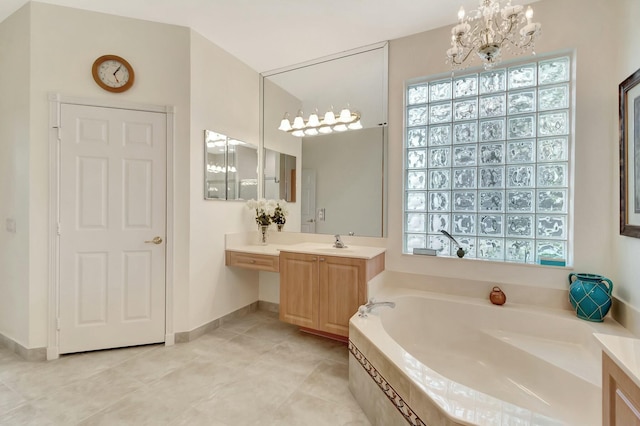 full bath featuring a chandelier, a wealth of natural light, vanity, and a bath