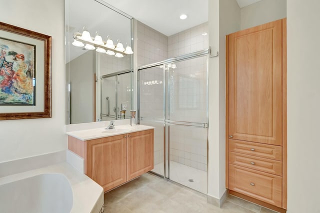 bathroom featuring a stall shower, a bath, and vanity