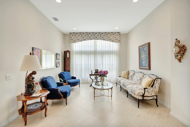 living room with recessed lighting, visible vents, and baseboards