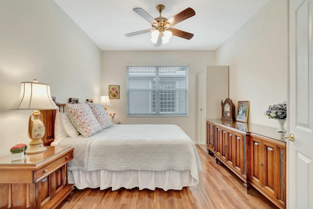 bedroom with light wood-style floors and a ceiling fan