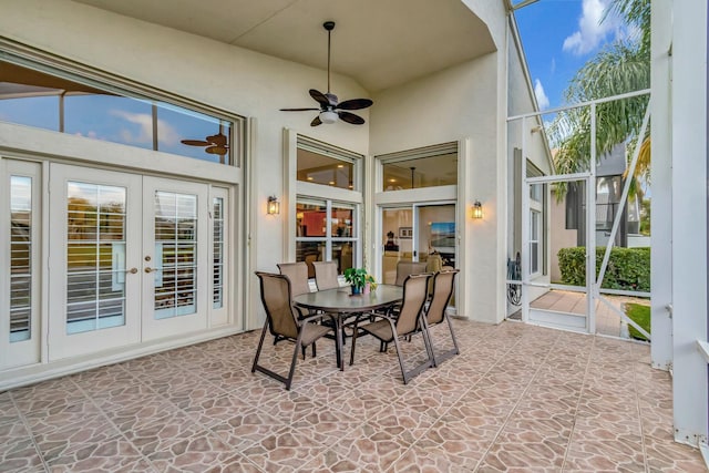 sunroom / solarium featuring a ceiling fan and french doors