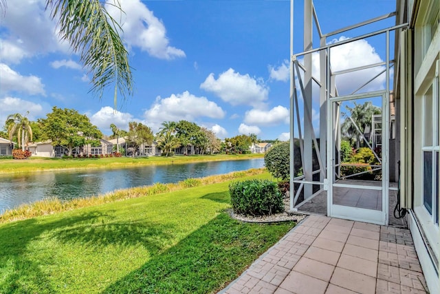 view of yard featuring a lanai and a water view