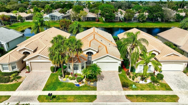 drone / aerial view featuring a residential view and a water view