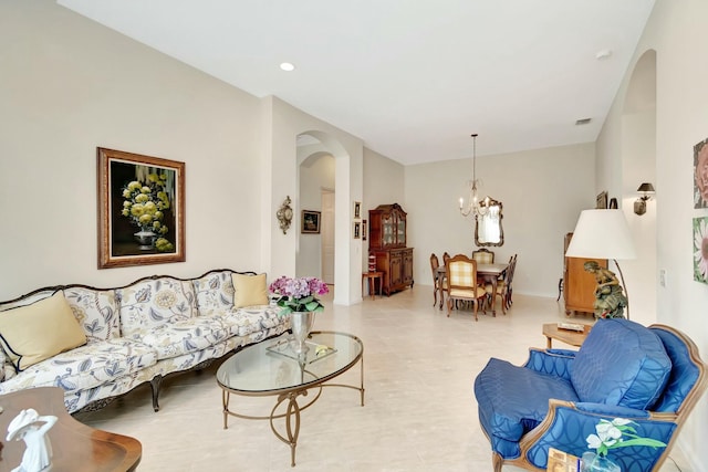 living area with arched walkways, visible vents, recessed lighting, and an inviting chandelier