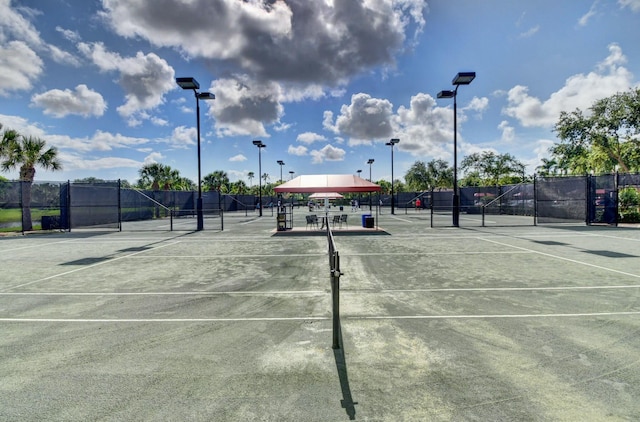 view of sport court featuring fence