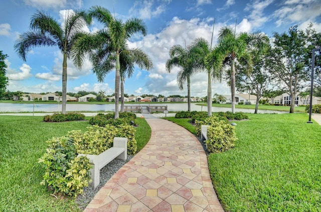 surrounding community with a lawn, a water view, and a residential view