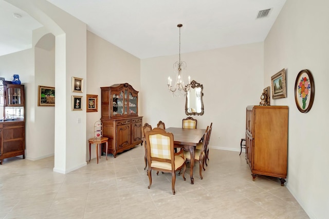 dining room featuring baseboards, lofted ceiling, visible vents, and a notable chandelier