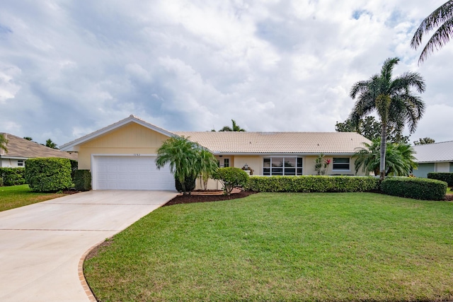 ranch-style house featuring a garage, concrete driveway, a front yard, and a tiled roof