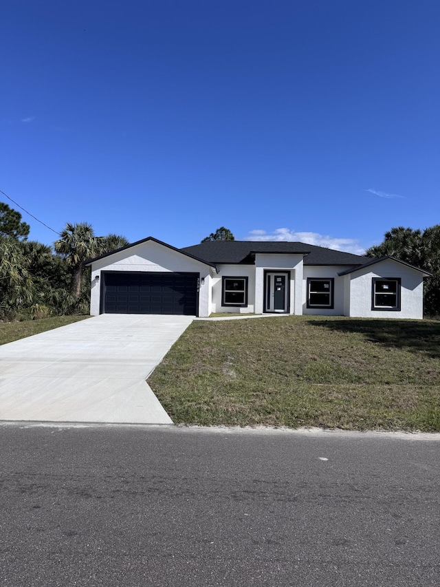 view of front facade with a front lawn and a garage