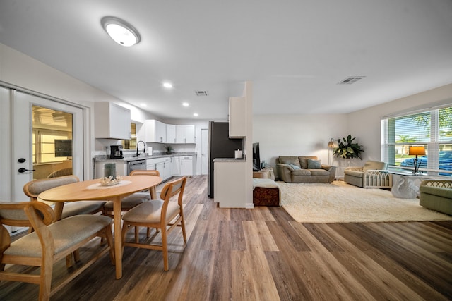 dining room featuring light wood finished floors, visible vents, and recessed lighting