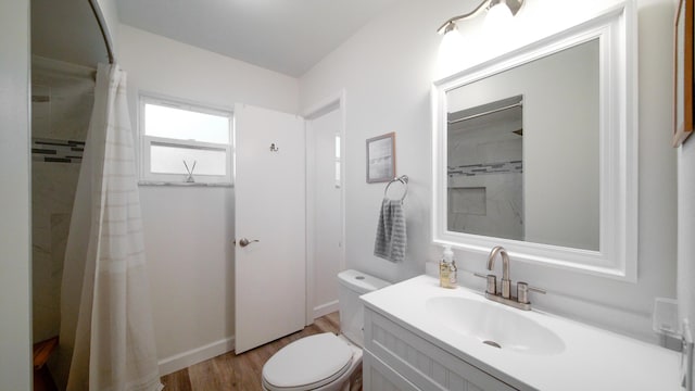 full bath with toilet, curtained shower, wood finished floors, and vanity