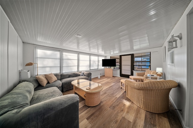 living area featuring wooden ceiling and wood finished floors