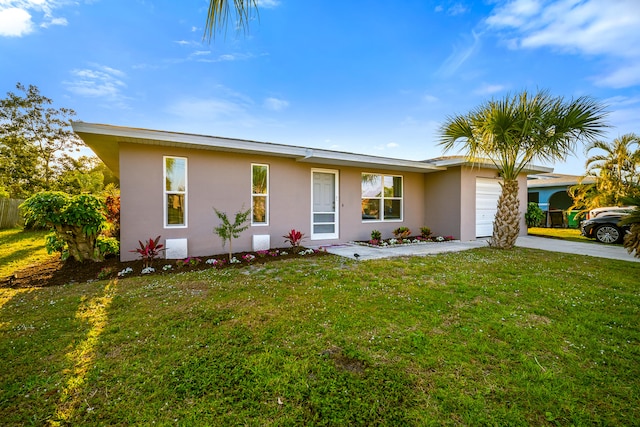 ranch-style house with a garage, concrete driveway, a front lawn, and stucco siding