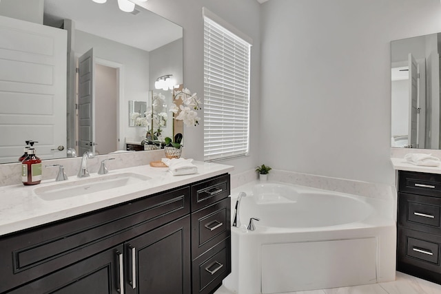 full bath featuring a garden tub and vanity