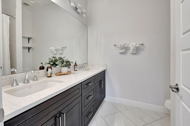 bathroom with toilet, a sink, visible vents, and baseboards