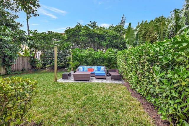 view of yard featuring a patio area, fence, and an outdoor living space