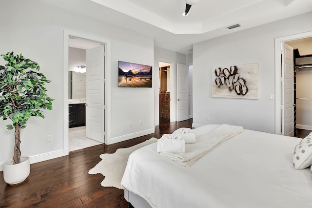 bedroom featuring a spacious closet, visible vents, and a closet