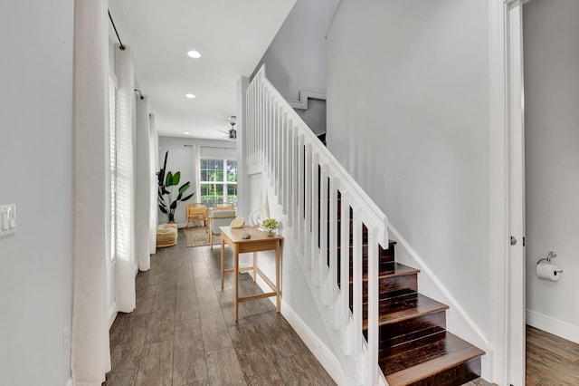 staircase featuring recessed lighting, baseboards, and wood finished floors