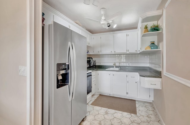 kitchen featuring open shelves, dark countertops, white cabinets, a sink, and stainless steel fridge with ice dispenser