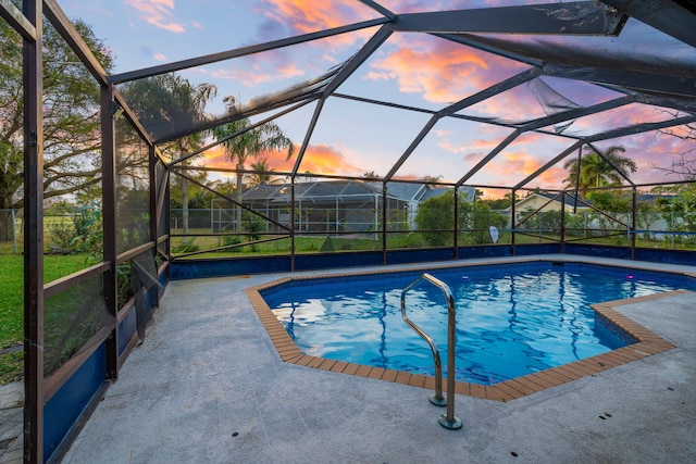 outdoor pool with a lanai and a patio area