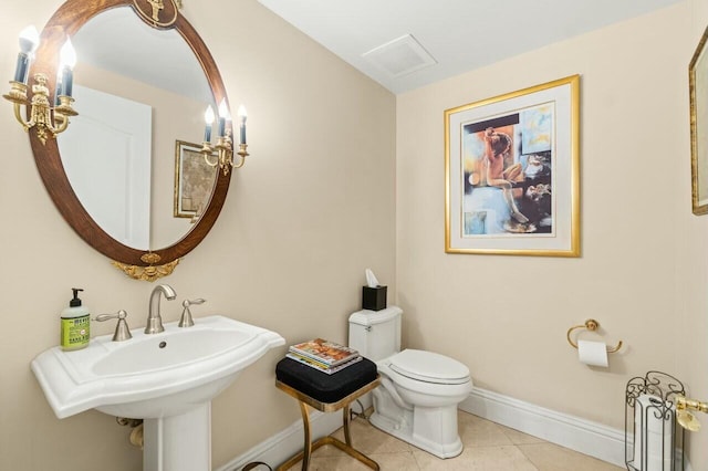 bathroom with sink, toilet, and tile patterned floors