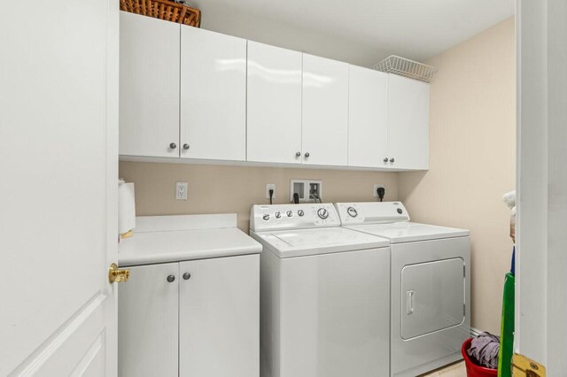 washroom with cabinets and separate washer and dryer