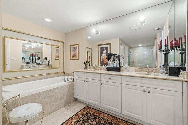 bathroom featuring vanity, independent shower and bath, and tile patterned floors