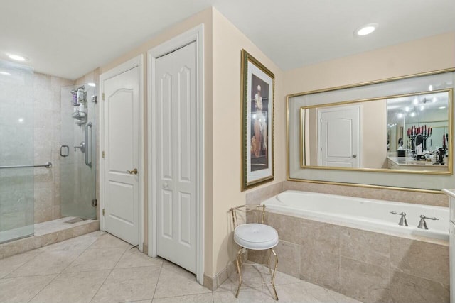 bathroom featuring independent shower and bath and tile patterned flooring