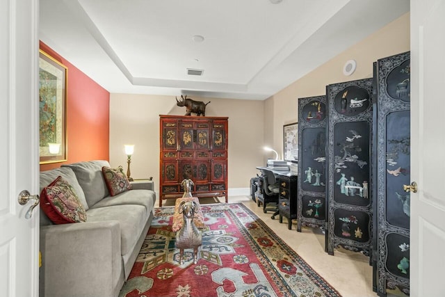 living room featuring a tray ceiling