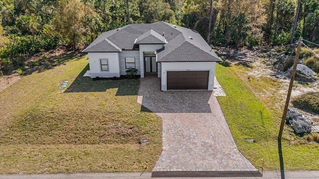 view of front of property with a front lawn and a garage