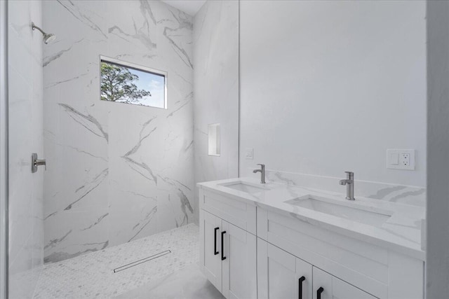 bathroom featuring a tile shower and vanity