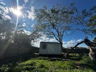 view of shed featuring fence