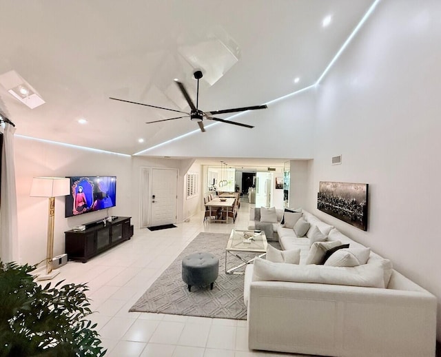 living room featuring ceiling fan, light tile patterned flooring, and high vaulted ceiling