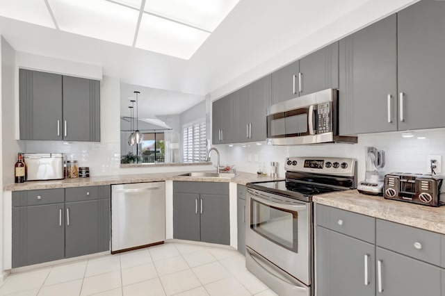 15334 Strathearn Dr Unit 12104, Delray Beach, FL 33446 - kitchen with appliances with stainless steel finishes, gray cabinets, decorative backsplash, and light countertops