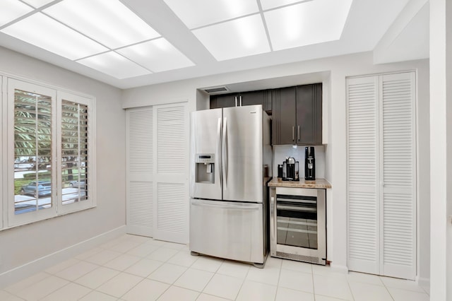 15334 Strathearn Dr Unit 12104, Delray Beach, FL 33446 - kitchen featuring stainless steel fridge, beverage cooler, dark brown cabinets, and light stone counters