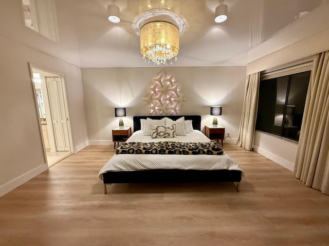 15334 Strathearn Dr Unit 12104, Delray Beach, FL 33446 - bedroom featuring light wood-style flooring and a chandelier