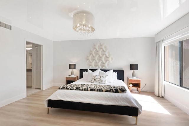 15334 Strathearn Dr Unit 12104, Delray Beach, FL 33446 - bedroom with light wood-style flooring, a chandelier, and ensuite bath