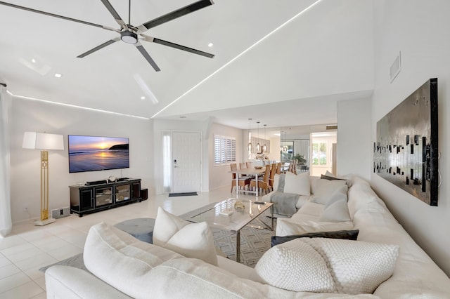 living room featuring ceiling fan, light tile patterned floors, and high vaulted ceiling