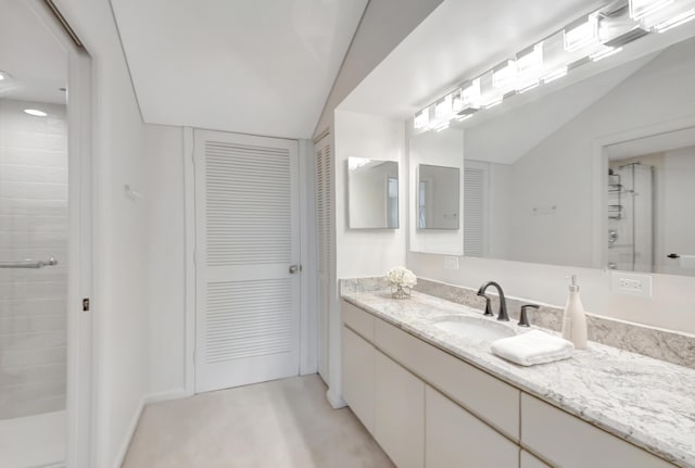 15334 Strathearn Dr Unit 12104, Delray Beach, FL 33446 - bathroom with a closet, vanity, a tile shower, and lofted ceiling