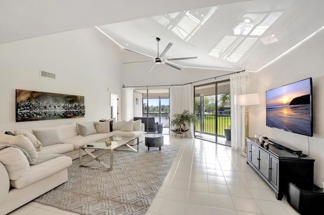 15334 Strathearn Dr Unit 12104, Delray Beach, FL 33446 - living room featuring high vaulted ceiling, ceiling fan, light tile patterned flooring, and a skylight