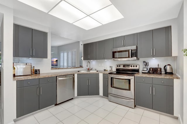 15334 Strathearn Dr Unit 12104, Delray Beach, FL 33446 - kitchen featuring appliances with stainless steel finishes, gray cabinets, light countertops, and decorative backsplash